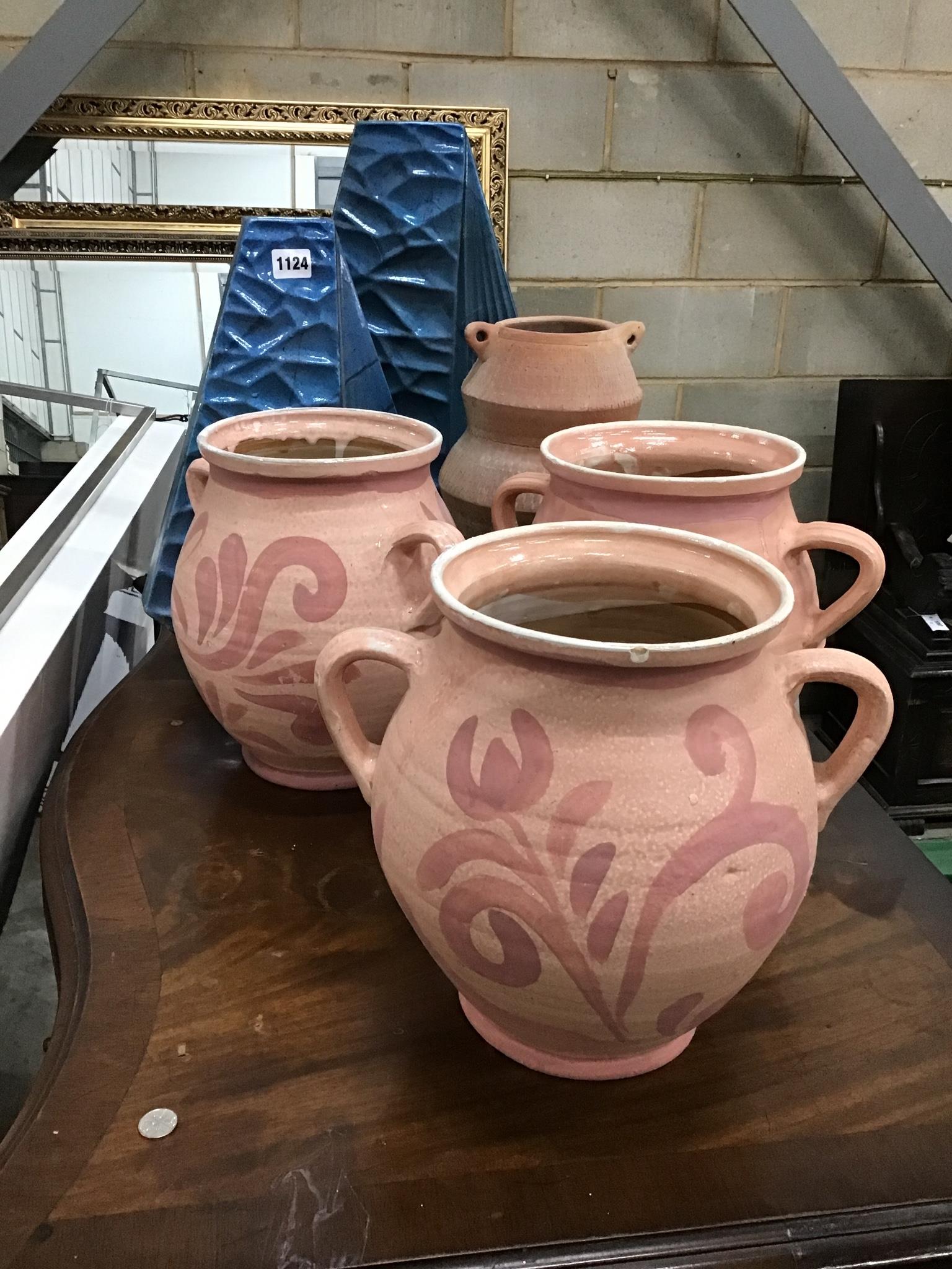 A set of three glazed pottery two handled vases, a pair of modernist vases and one other.